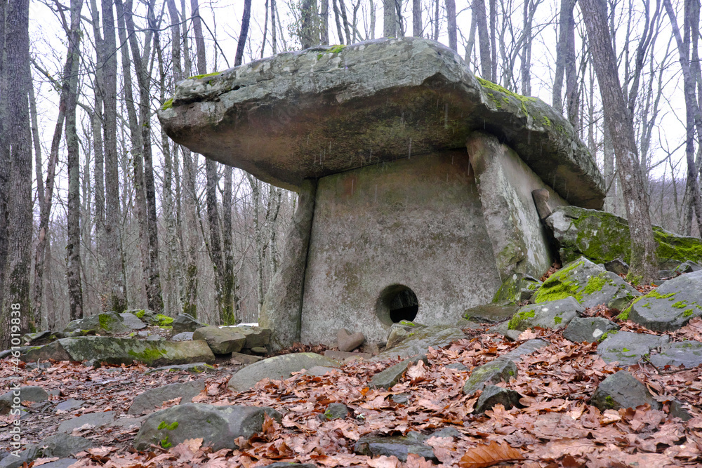 View of ancient dolmen in Pshada river gorge on cloudy winter day. Krasnodar Krai, Caucasus, Russia. View of ancient dolmen in Pshada river gorge on cloudy winter day. Krasnodar Krai, Caucasus, Russia.