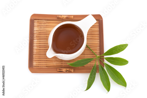 Edible-stemmed Vine or schefflera leucantha green leaves and tea isolated on white background