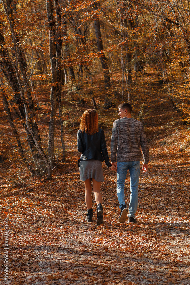 A young couple in love in the autumn forest A young couple in love in the autumn forest