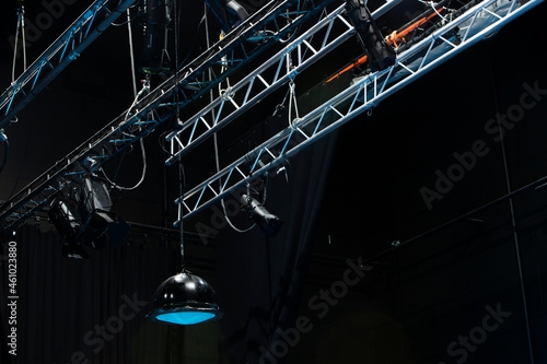 photo from below of metal stage with theater lights photo