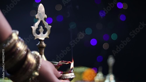 Married Girl Lits Large Brass Panchmukhi Diya Or Deep. Diwali Puja New Year Deepawali Ganesh Chaturthi Or Shubh Deepavali Pooja Celebration Theme. Beautiful Bokeh Effect In Background photo