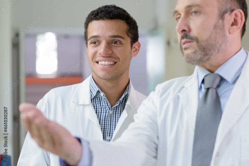 male doctor training junior colleague male doctor training junior colleague
