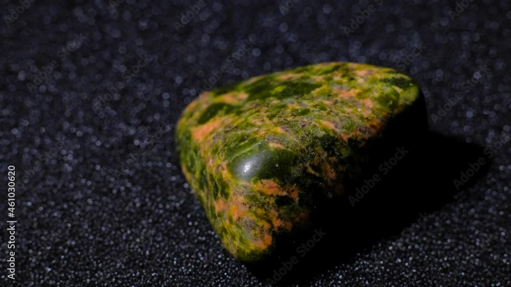 Natural gemstone polished Unakite rotation 360 over black background. 4k. Macro shot. Natural gemstone polished Unakite rotation 360 over black background. 4k. Macro shot.