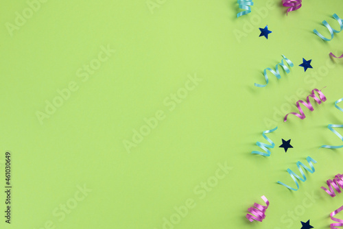 Serpentine and stars, on green  background. Celebration concept .Flat lay, top view, copy space. © Konstantin Maslak
