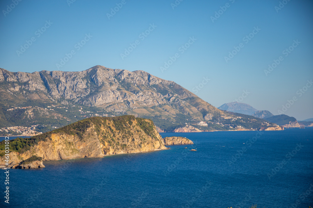Aerial view of Sveti Nikola or St. Nicolas island is in Budva riviera on mountain background, Montenegro