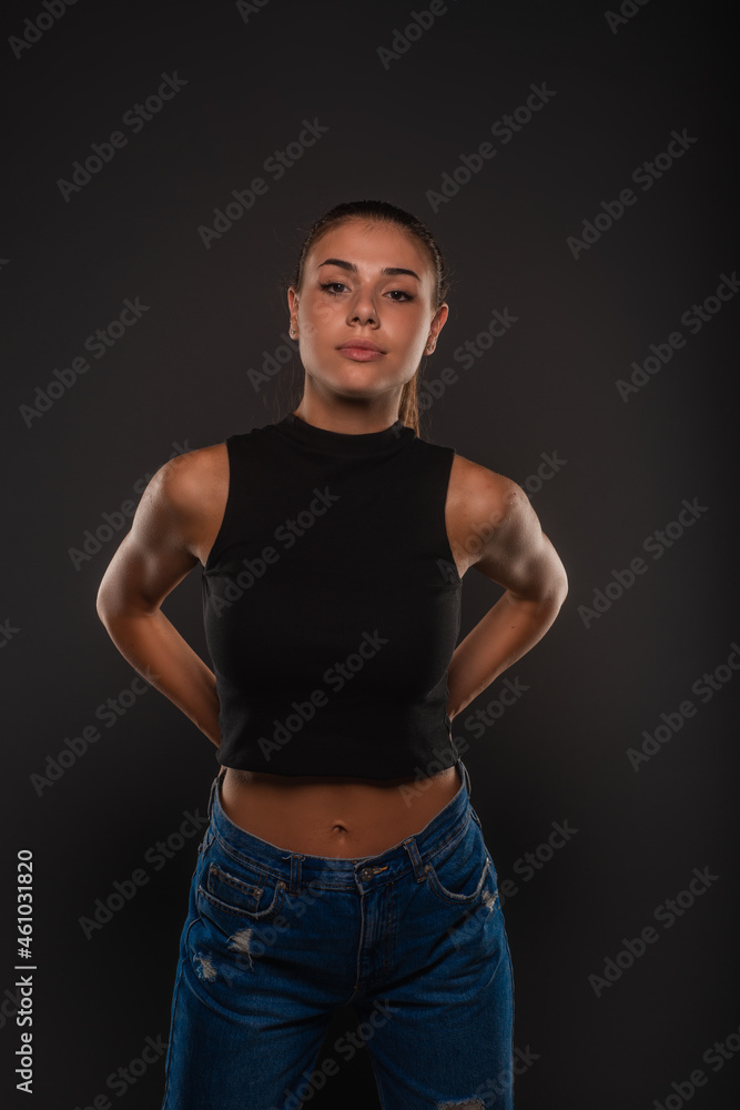 Posing with her hands behind while having a serious face Posing with her hands behind while having a serious face