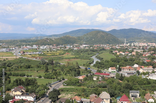 village in the valley. Scenic view of the town in the mountains on a cloudy summer day.