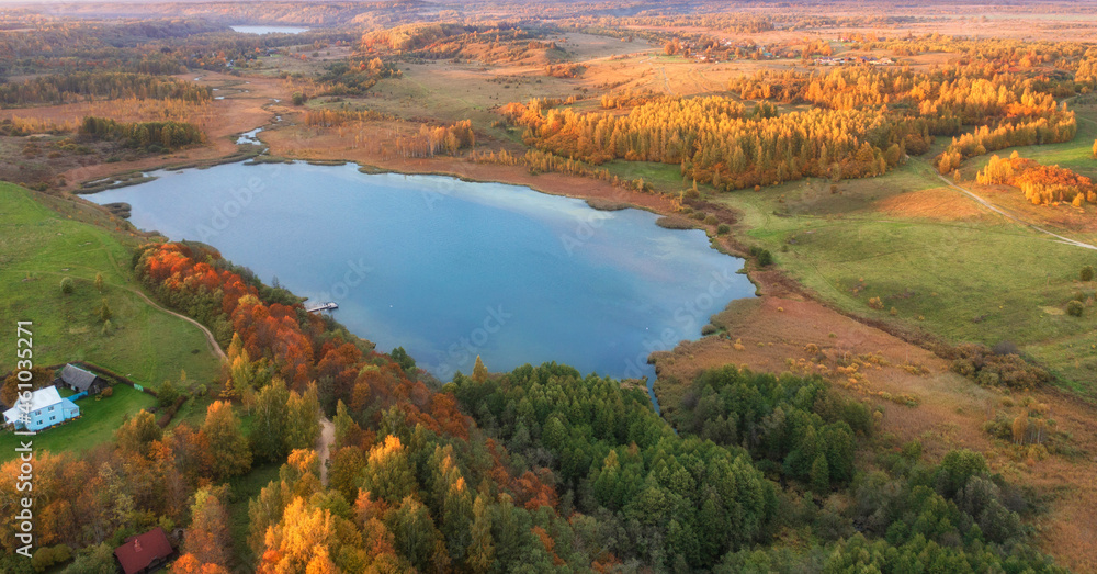 Malskaya valley and Gorodischenskoye lake near the town of Izborsk in the Pskov region of Russia during the golden autumn. Autumn landscape top view.