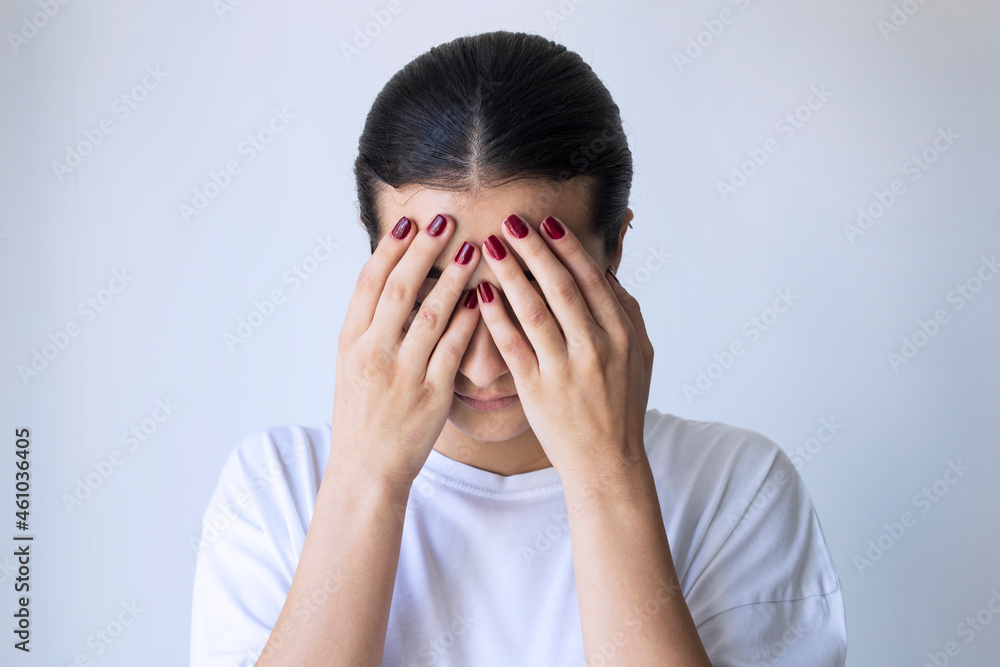 Young girl covering her face with her hands Young girl covering her face with her hands