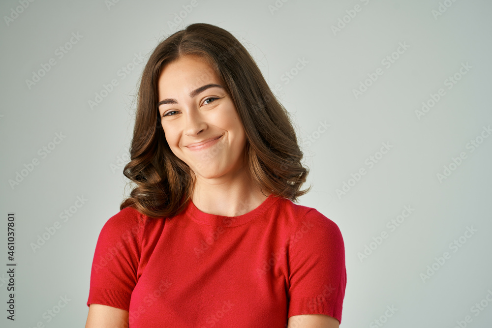 Obraz premium beautiful woman in a red t-shirt hair care light background