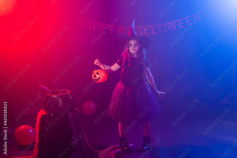 Little girl holds pumpkin jack on Halloween holiday. Kid girl wear witch costume. Fantasy, fairy tale and masquerade concept. Little girl holds pumpkin jack on Halloween holiday. Kid girl wear witch costume. Fantasy, fairy tale and masquerade concept.