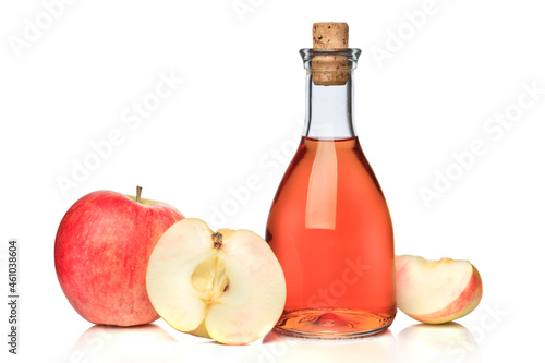 Bottle of apple cider and red apples isolated on white background.