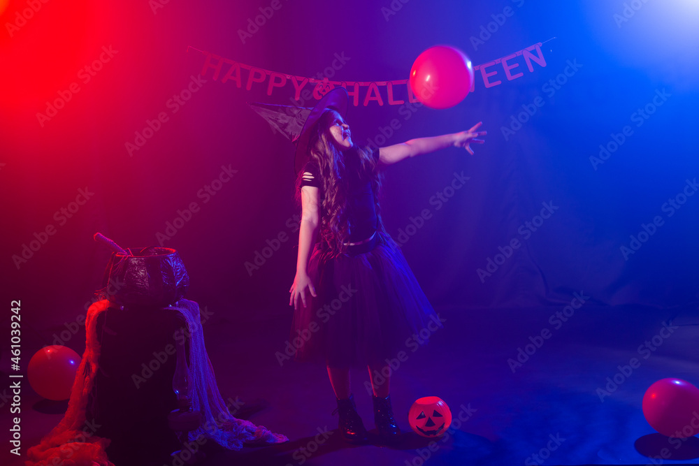 Funny child girl in witch costume for Halloween with pumpkin Jack. Funny child girl in witch costume for Halloween with pumpkin Jack.