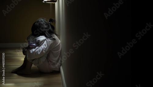 Squat single child sit near window, sad lonely in dark night indoor, crying, bad mood, offended, consoles,  concept of unhappy childhood, life together
