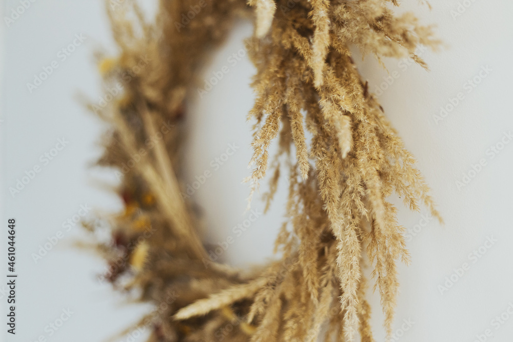 Creative boho wreath with dried pampas grass, wildflowers, wheat, on white wall. Stylish autumn rustic wreath, details close up. Hello Fall. Happy Thanksgiving. Space for text Creative boho wreath with dried pampas grass, wildflowers, wheat, on white wall. Stylish autumn rustic wreath, details close up. Hello Fall. Happy Thanksgiving. Space for text