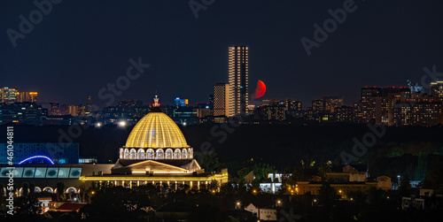 Moon over the city at night. Moscow, Russia