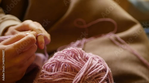 Close up woman knitting woolen sweater with needles. Relaxing hobby. 4k video. Winter holidays craft 