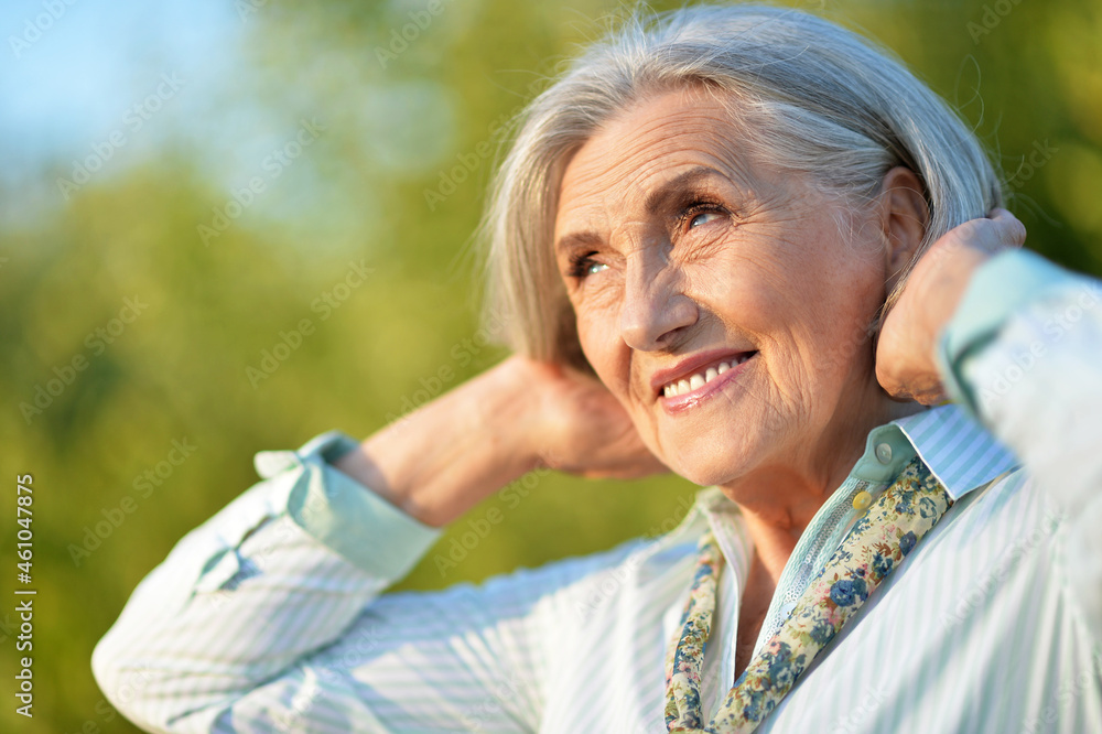 Close up portrait of happy senior woman in park Close up portrait of happy senior woman in park