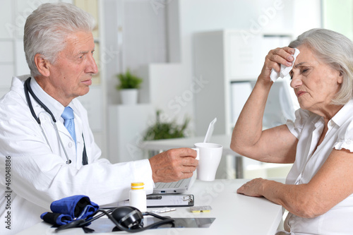Portrait of senior doctor with a elderly patient