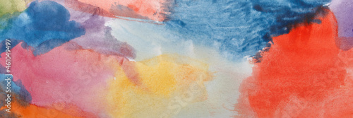 Colourful watercolour splatter. Art Abstract paint blots background. Alcohol ink in blue, orange, yellow and pink colors and shades. Horizontal long banner