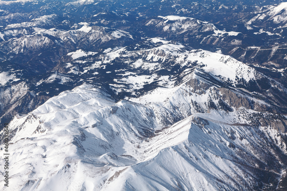 Fototapeta premium Aerial view of mountains covered by snow