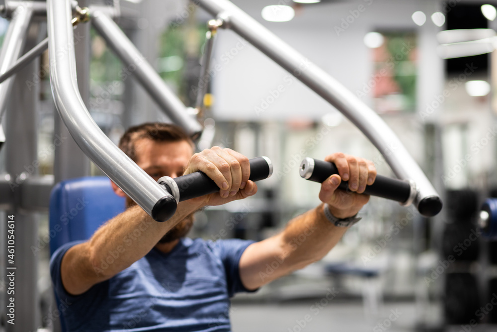 fit young man in sportswear trainings in a gym healthy active lifestyle fit young man in sportswear trainings in a gym healthy active lifestyle