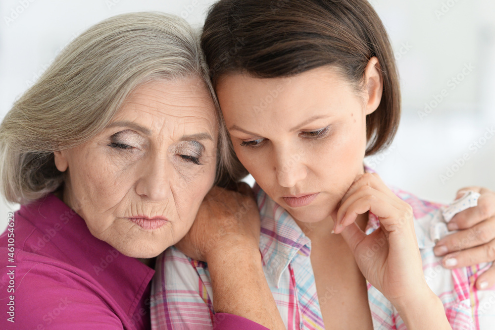 Portrait of sad senior woman with daughter Portrait of sad senior woman with daughter