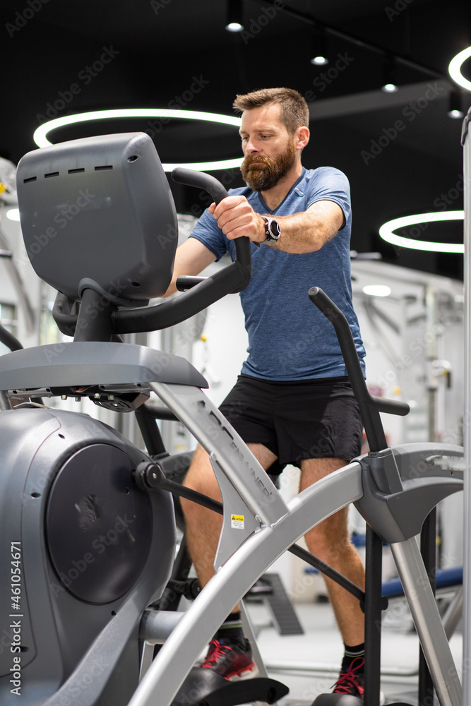 fit young man in sportswear trainings in a gym healthy active lifestyle fit young man in sportswear trainings in a gym healthy active lifestyle