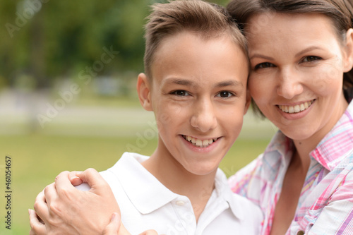 Portrait of beautiful mother with son in park