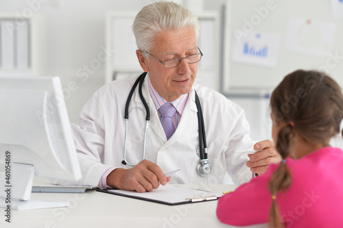 Portrait of happy young family visiting doctor