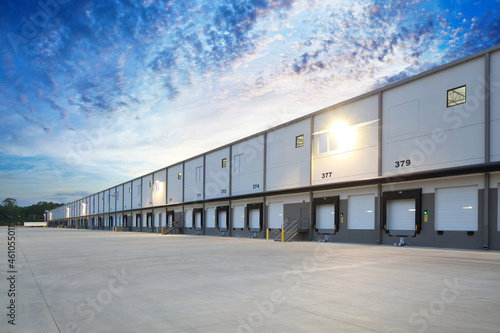 Exterior of modern distribution center warehouse at sunrise