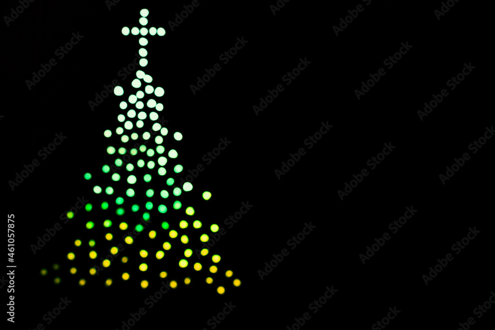 christmas tree isolated on black background with colorful blurred lights. Merry Christmas. Abstract. christmas tree isolated on black background with colorful blurred lights. Merry Christmas. Abstract.