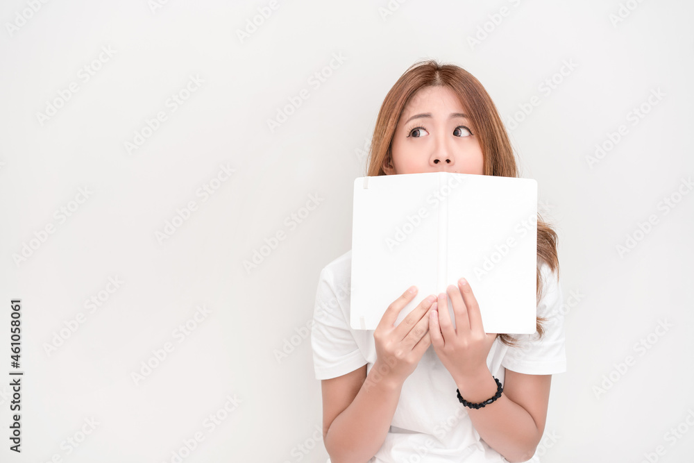 Young attractive asian student holding books in her arm on white background. School girl with a books to read for homework. Young attractive asian student holding books in her arm on white background. School girl with a books to read for homework.