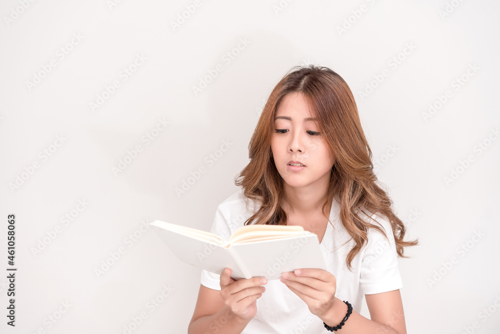 Young attractive asian student holding books in her arm on white background. School girl with a books to read for homework. Young attractive asian student holding books in her arm on white background. School girl with a books to read for homework.