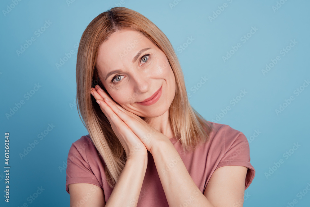 Closeup photo of attractive woman happy positive smile hands touch cheek isolated blue color background Closeup photo of attractive woman happy positive smile hands touch cheek isolated blue color background
