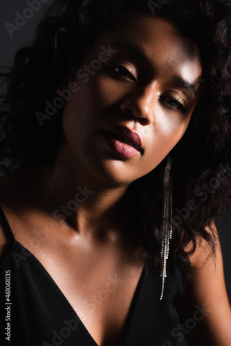 close up of sexy african american woman looking at camera isolated on black