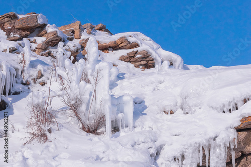 Wallpaper Mural Winter Baikal. Dry grass on the rocky slope is covered with ice and snow. Natural background Torontodigital.ca