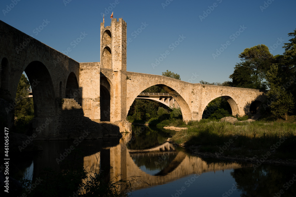 Medieval stone bridge over river at sunset, Besalu Catalonia, Spain