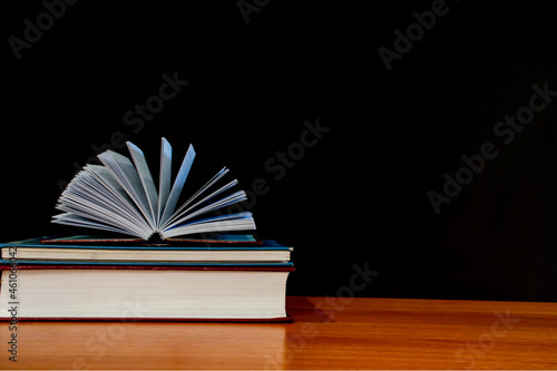 The book is placed on the brown table. black background