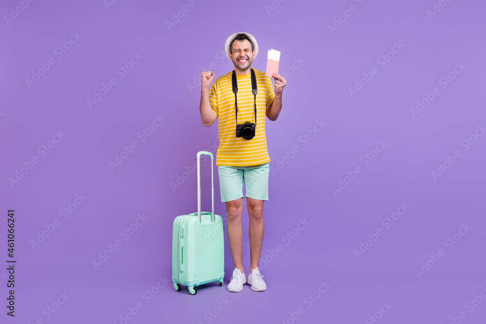 Full length body size photo man in hat keeping bags tickets won trip isolated pastel violet color background Full length body size photo man in hat keeping bags tickets won trip isolated pastel violet color background