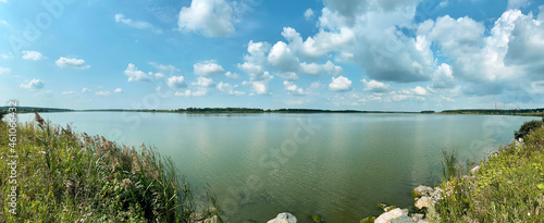 Fototapeta Naklejka Na Ścianę i Meble -  Panoramic view of the lake under the sky with beautiful clouds
