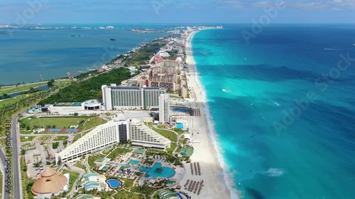 Caribbean white unspoiled sandy beach aerial drone view. Flying over Cancun bay in Yucatán Peninsula in the Mexican state of Quintana Roo. Tourist hotel resort complex on paradisiacal beaches. White 