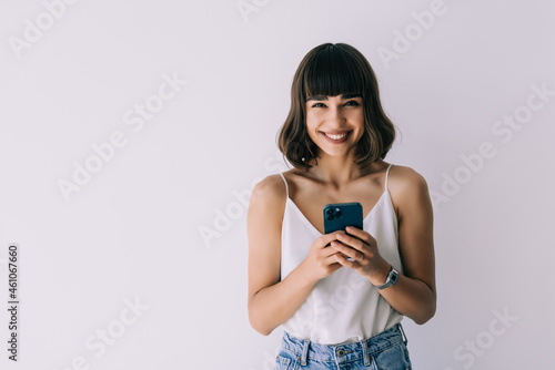 Young Woman wearing using a mobile phone isolated on a white background