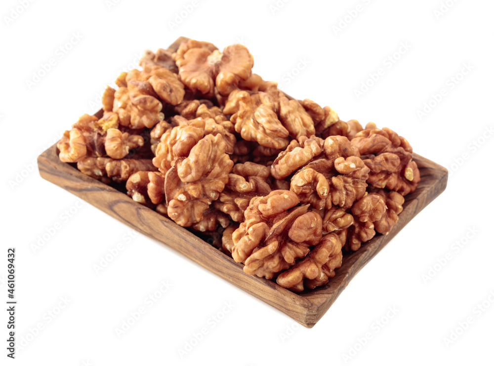 Walnuts in wooden dish isolated on white. Walnuts in wooden dish isolated on white.
