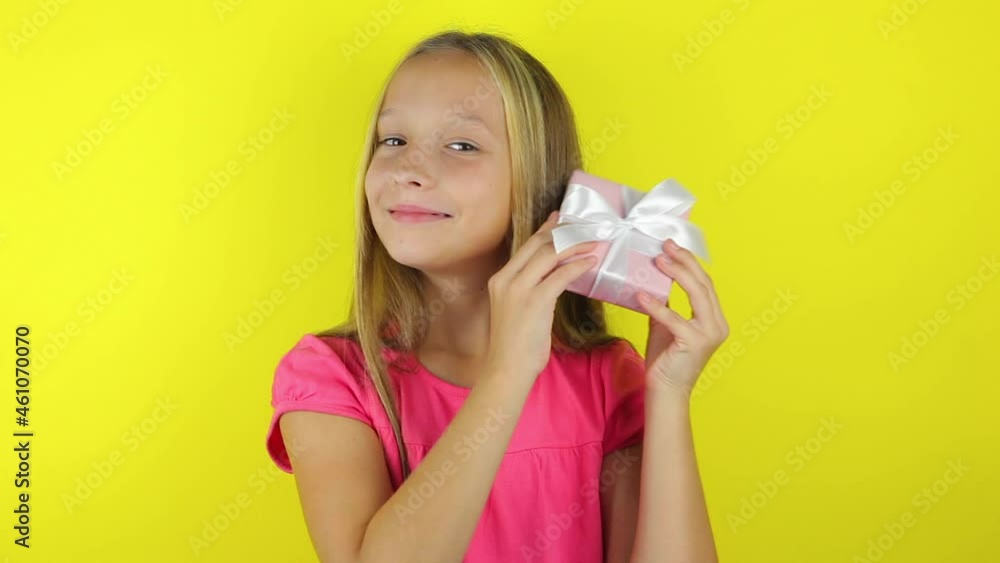 girl with a gift on a colored background close-up girl with a gift on a colored background close-up