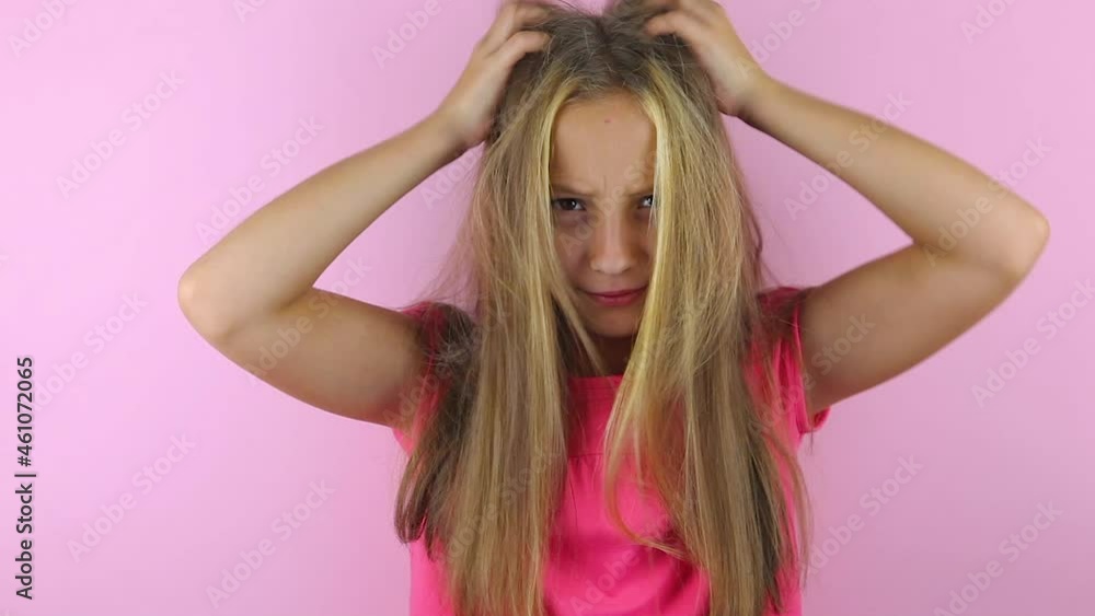 Girl scratches her head on a colored background Girl scratches her head on a colored background