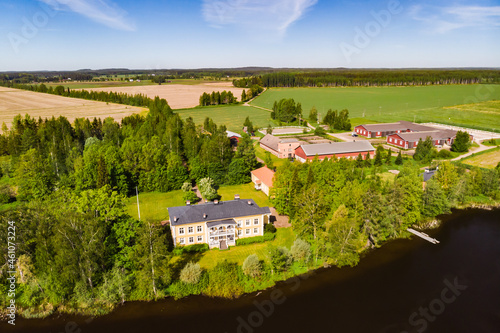 Kouvola, Finland - June 3, 2021: Aerial view of beautiful wooden Rabbelugn Manor - Takamaan Kartano. River Kymijoki bank. photo