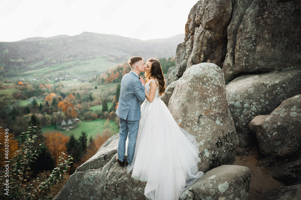 Loving husband and woman on the background of the mountains. Loving couple emotionally spends time Loving husband and woman on the background of the mountains. Loving couple emotionally spends time