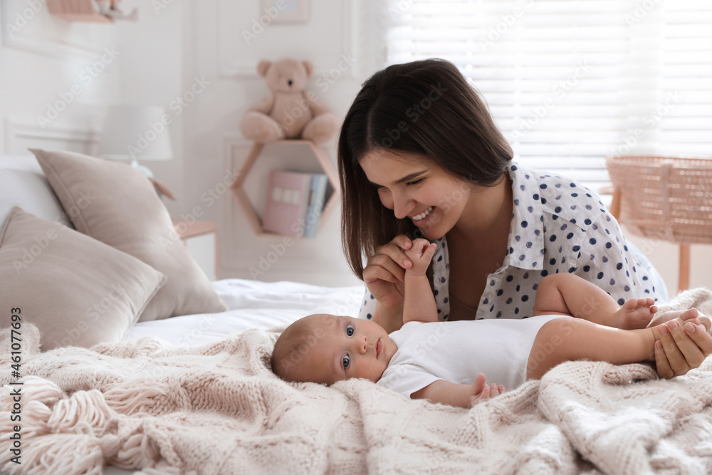 Mother with her cute baby on bed at home Mother with her cute baby on bed at home