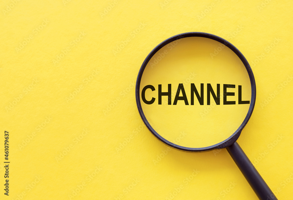 The word CHANNEL is written on a magnifying glass on a yellow background. The word CHANNEL is written on a magnifying glass on a yellow background.